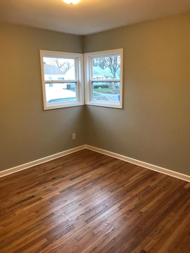 2649 Hiawatha St, Columbus, OH 43211 - unfurnished room featuring plenty of natural light, dark wood finished floors, and baseboards