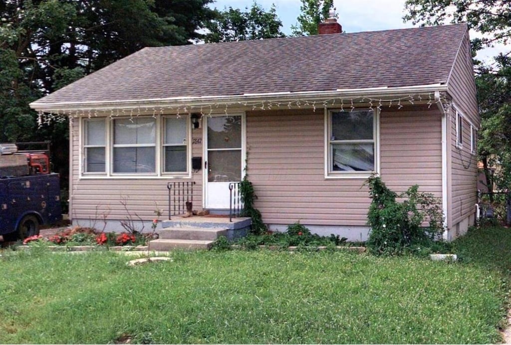 1847 Agler Rd, Columbus, OH 43224 - bungalow-style house featuring a chimney, a front lawn, and roof with shingles