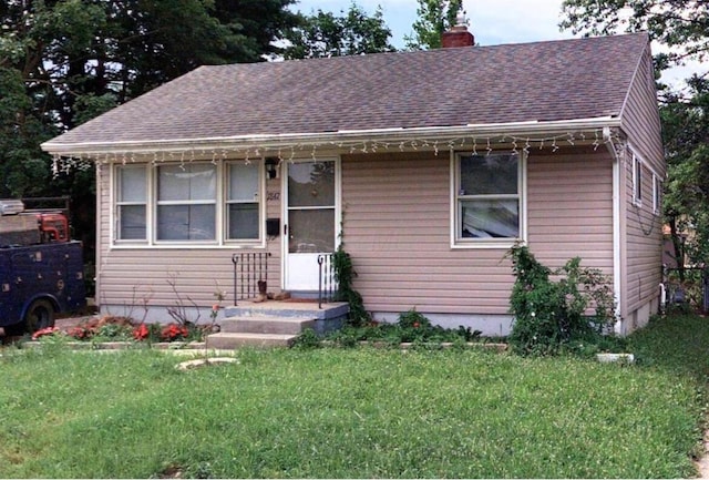 1847 Agler Rd, Columbus, OH 43224 - bungalow-style house featuring a chimney, a front lawn, and roof with shingles