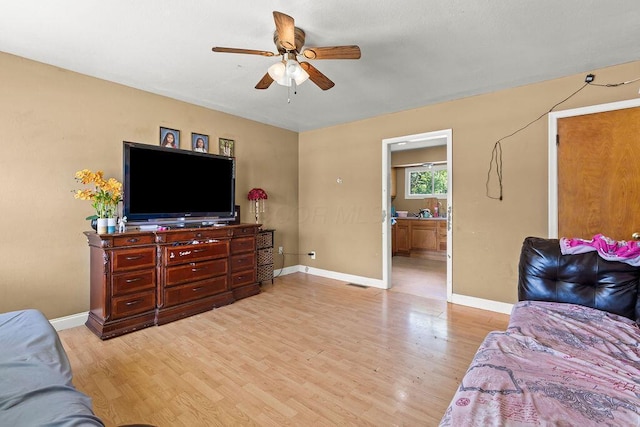 1847 Agler Rd, Columbus, OH 43224 - bedroom with light wood-style floors, connected bathroom, and a ceiling fan