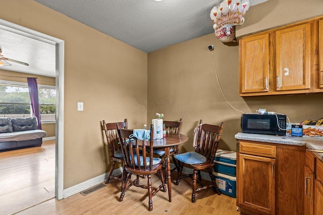 1847 Agler Rd, Columbus, OH 43224 - dining space with light wood finished floors, a textured ceiling, and ceiling fan