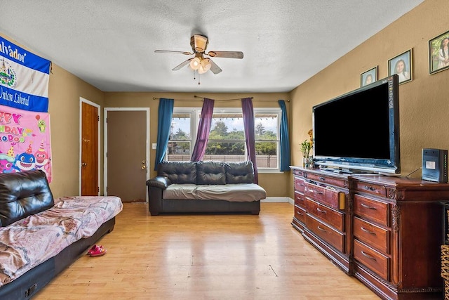1847 Agler Rd, Columbus, OH 43224 - living room with ceiling fan, light wood finished floors, and a textured ceiling