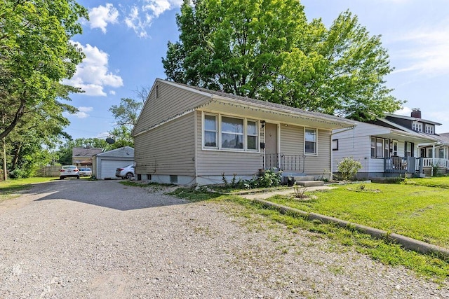 1847 Agler Rd, Columbus, OH 43224 - bungalow-style home featuring a front yard, a detached garage, and an outdoor structure