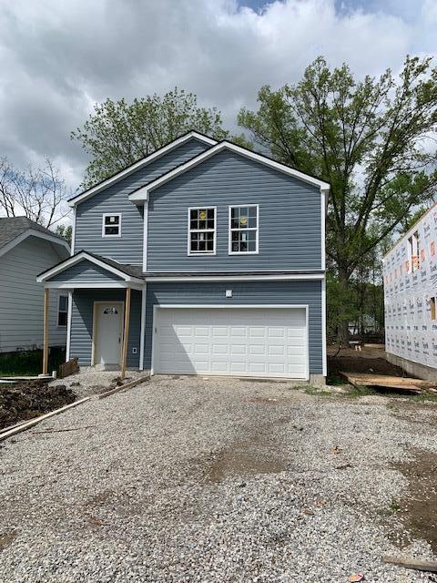 2582 Adda Ave, Columbus, OH 43231 - view of front facade with gravel driveway and a garage