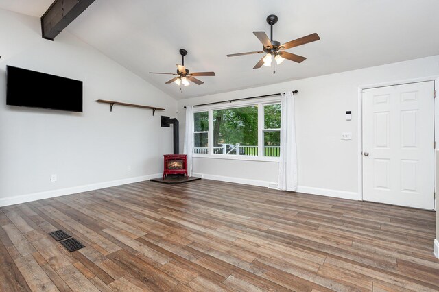 2914 Hickory Hill Dr SE, Lancaster, OH 43130 - unfurnished living room with a wood stove, ceiling fan, wood finished floors, and baseboards