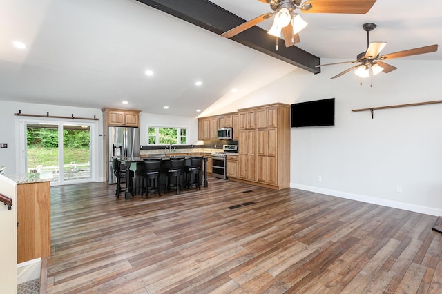 2914 Hickory Hill Dr SE, Lancaster, OH 43130 - kitchen with stainless steel appliances, a kitchen island, light wood finished floors, a kitchen bar, and recessed lighting