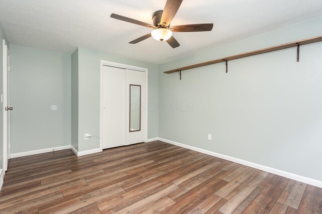 2914 Hickory Hill Dr SE, Lancaster, OH 43130 - unfurnished bedroom with wood finished floors, baseboards, a closet, and a ceiling fan