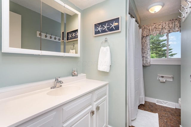 2914 Hickory Hill Dr SE, Lancaster, OH 43130 - full bathroom featuring vanity, baseboards, toilet, and a textured ceiling