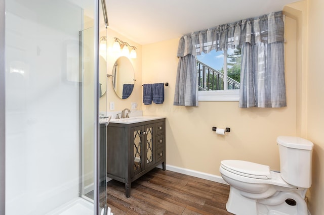2914 Hickory Hill Dr SE, Lancaster, OH 43130 - full bathroom featuring toilet, vanity, wood finished floors, a stall shower, and baseboards