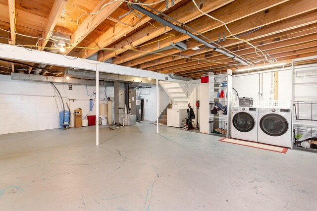 2914 Hickory Hill Dr SE, Lancaster, OH 43130 - unfinished below grade area featuring separate washer and dryer, stairway, electric water heater, and a water pressure tank