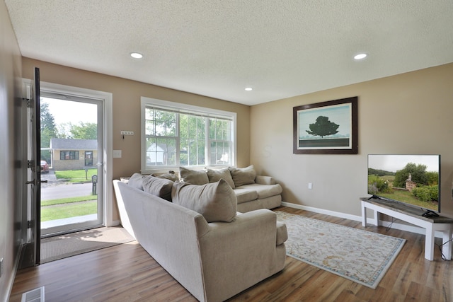 4511 Collingdale Rd, Columbus, OH 43231 - living area with a textured ceiling, wood finished floors, baseboards, and recessed lighting
