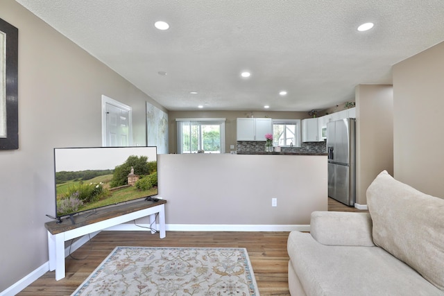 4511 Collingdale Rd, Columbus, OH 43231 - living area featuring wood finished floors, baseboards, recessed lighting, and a textured ceiling