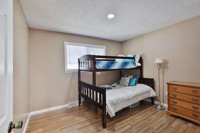 4511 Collingdale Rd, Columbus, OH 43231 - bedroom with light wood-style floors, a textured ceiling, baseboards, and recessed lighting