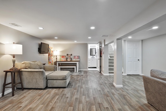 4511 Collingdale Rd, Columbus, OH 43231 - living room with wood finished floors, recessed lighting, baseboards, and stairs