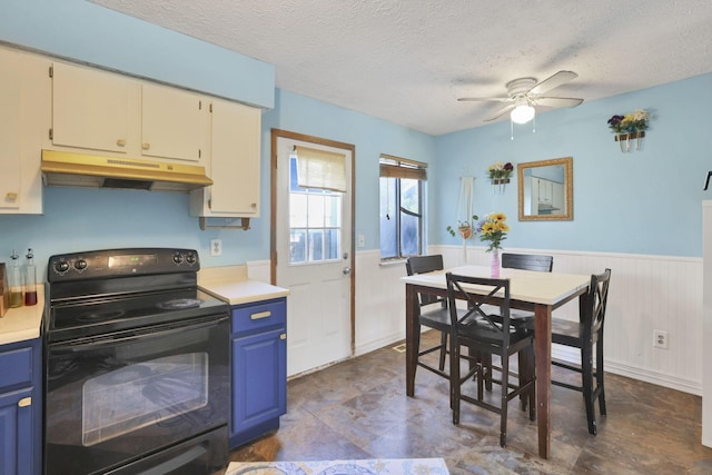 7347 Fall Creek Ln Unit J, Columbus, OH 43235 - kitchen with black electric range, under cabinet range hood, blue cabinetry, a ceiling fan, and a textured ceiling