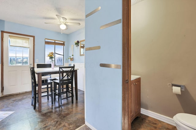 7347 Fall Creek Ln Unit J, Columbus, OH 43235 - dining room with ceiling fan, baseboards, and a textured ceiling