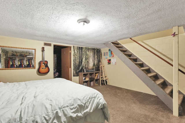 7347 Fall Creek Ln Unit J, Columbus, OH 43235 - bedroom featuring a textured ceiling, carpet floors, and concrete block wall