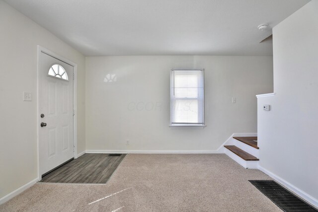 784 E Mithoff St, Columbus, OH 43206 - foyer entrance featuring carpet flooring, baseboards, and stairway