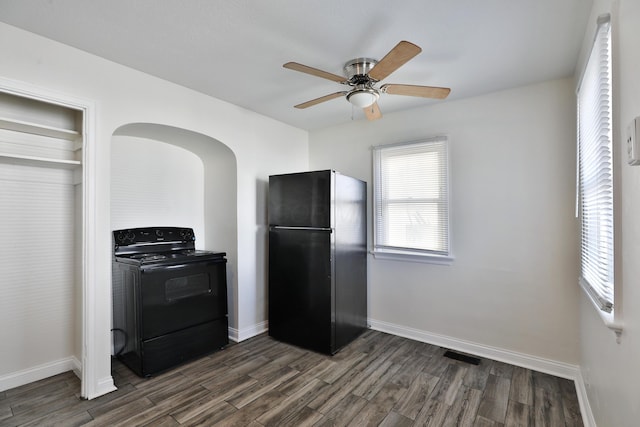 784 E Mithoff St, Columbus, OH 43206 - kitchen featuring black appliances, dark wood-style flooring, baseboards, arched walkways, and ceiling fan