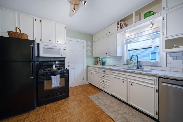 297 E Welch Ave, Columbus, OH 43207 - kitchen featuring black appliances, a sink, white cabinetry, tasteful backsplash, and light stone countertops