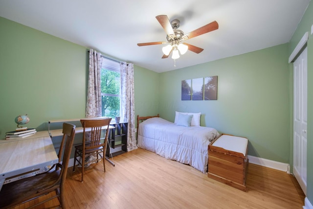 297 E Welch Ave, Columbus, OH 43207 - bedroom with wood finished floors, a closet, baseboards, and a ceiling fan