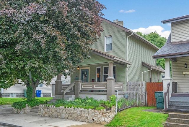 297 E Welch Ave, Columbus, OH 43207 - view of front facade with a porch and a chimney