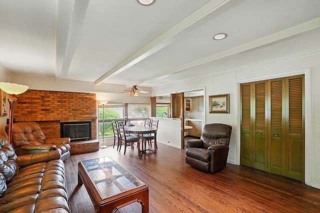 1120 Morning St, Worthington, OH 43085 - living room with a ceiling fan, beam ceiling, dark wood finished floors, and a fireplace