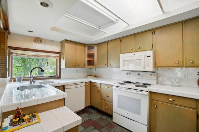 1120 Morning St, Worthington, OH 43085 - kitchen with white appliances, a sink, tasteful backsplash, tile countertops, and dark stone finish flooring