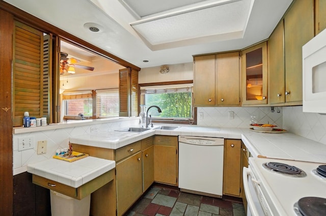 1120 Morning St, Worthington, OH 43085 - kitchen with white appliances, a sink, decorative backsplash, and tile countertops