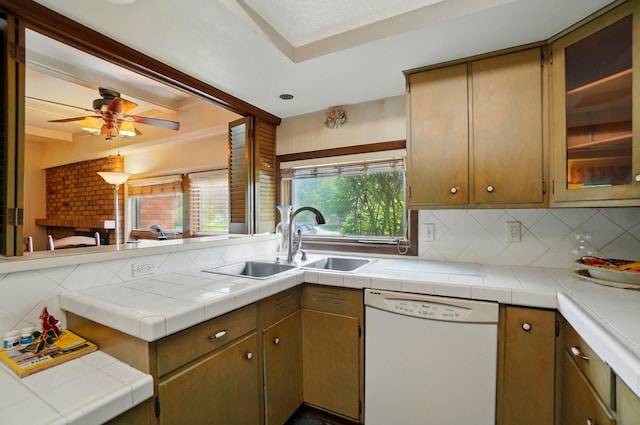 1120 Morning St, Worthington, OH 43085 - kitchen featuring white dishwasher, a sink, backsplash, glass insert cabinets, and ceiling fan