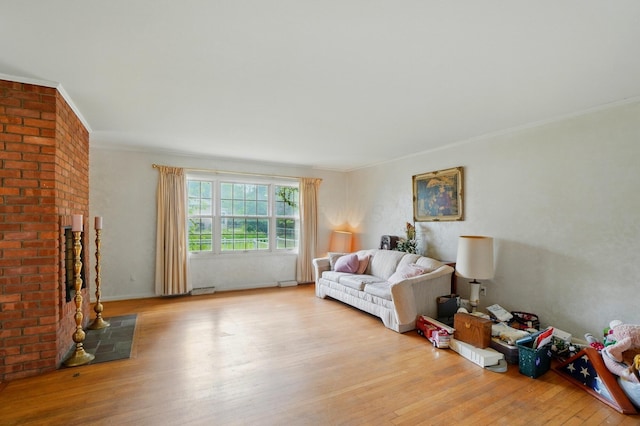 1120 Morning St, Worthington, OH 43085 - living room with light wood-style floors, crown molding, and a fireplace