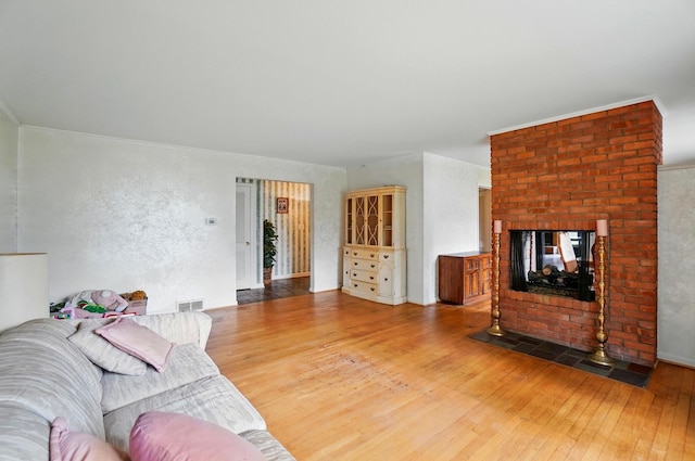 1120 Morning St, Worthington, OH 43085 - living area featuring hardwood / wood-style floors, a brick fireplace, and ornamental molding