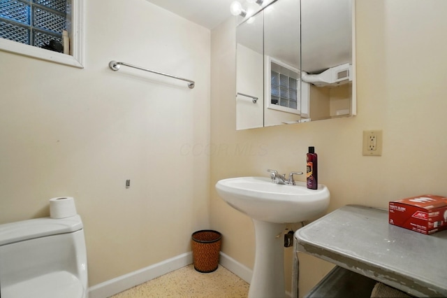 1120 Morning St, Worthington, OH 43085 - bathroom featuring toilet, baseboards, and speckle patterned floor