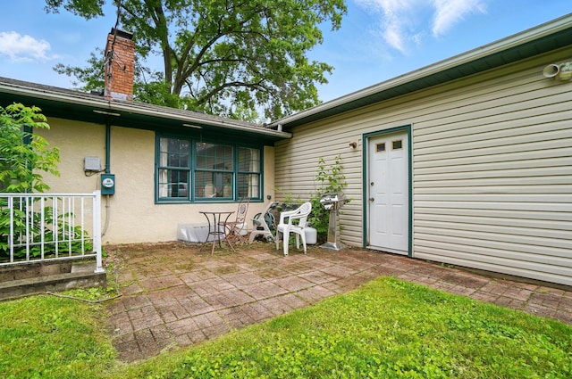 1120 Morning St, Worthington, OH 43085 - back of property featuring stucco siding, a patio, and a chimney
