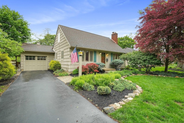 2314 Woodstock Rd, Columbus, OH 43221 - view of front of property featuring a chimney, a shingled roof, asphalt driveway, and a garage