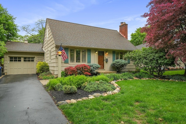 2314 Woodstock Rd, Columbus, OH 43221 - view of front facade with roof with shingles, driveway, a front yard, a garage, and a chimney