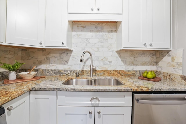2314 Woodstock Rd, Columbus, OH 43221 - kitchen with stainless steel dishwasher, a sink, white cabinetry, backsplash, and light stone countertops