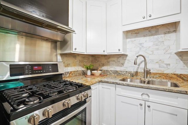 2314 Woodstock Rd, Columbus, OH 43221 - kitchen with stainless steel range with gas cooktop, a sink, white cabinetry, decorative backsplash, and light stone countertops