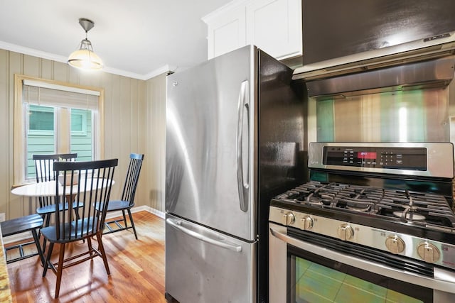2314 Woodstock Rd, Columbus, OH 43221 - kitchen with stainless steel appliances, crown molding, white cabinetry, light wood-style floors, and range hood