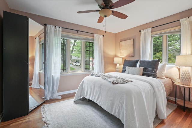 2314 Woodstock Rd, Columbus, OH 43221 - bedroom featuring baseboards, wood finished floors, and a ceiling fan