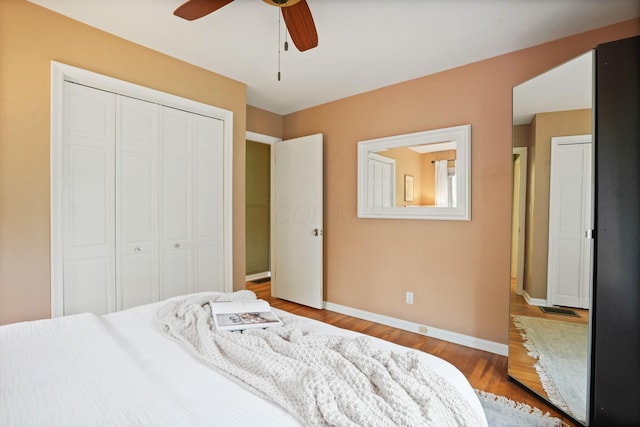 2314 Woodstock Rd, Columbus, OH 43221 - bedroom featuring a closet, baseboards, wood finished floors, and ceiling fan
