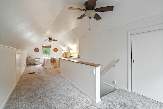 2314 Woodstock Rd, Columbus, OH 43221 - hallway featuring carpet flooring, lofted ceiling, an upstairs landing, and baseboards