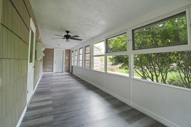 2314 Woodstock Rd, Columbus, OH 43221 - unfurnished sunroom featuring wood finished floors, a ceiling fan, a textured ceiling, and baseboards