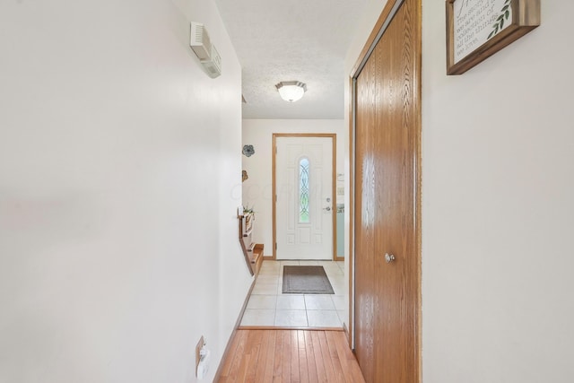 5046 Rolling Rock Ct, Columbus, OH 43229 - entryway with a textured ceiling, light wood-type flooring, and baseboards