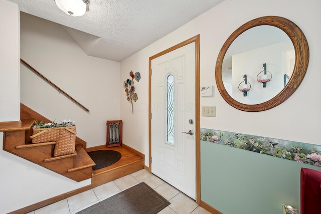 5046 Rolling Rock Ct, Columbus, OH 43229 - entrance foyer with stairway, light tile patterned flooring, a textured ceiling, and baseboards