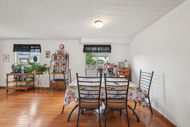 5046 Rolling Rock Ct, Columbus, OH 43229 - dining area with hardwood / wood-style floors, a textured ceiling, and baseboards