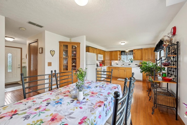 5046 Rolling Rock Ct, Columbus, OH 43229 - dining space featuring light wood-style floors and a textured ceiling