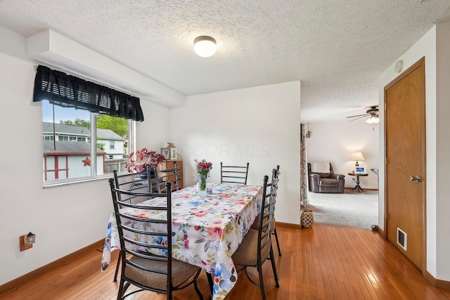 5046 Rolling Rock Ct, Columbus, OH 43229 - dining area with a textured ceiling, hardwood / wood-style flooring, baseboards, and a ceiling fan