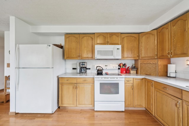 5046 Rolling Rock Ct, Columbus, OH 43229 - kitchen with white appliances, light wood-type flooring, light countertops, and a textured ceiling