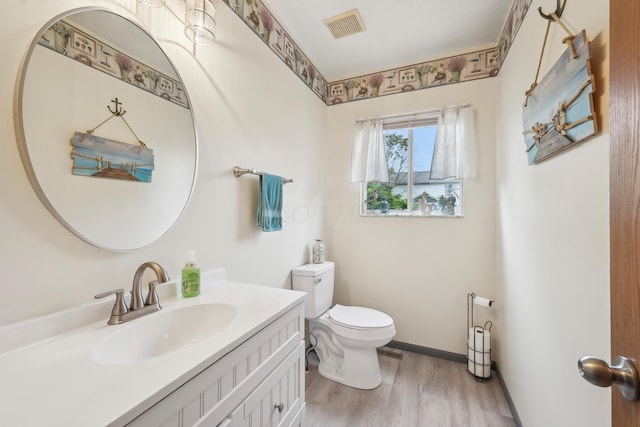 5046 Rolling Rock Ct, Columbus, OH 43229 - half bath featuring toilet, wood finished floors, and vanity